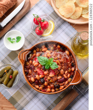 A colorful Western-style table with lots of ingredients and chili con carne 128366522