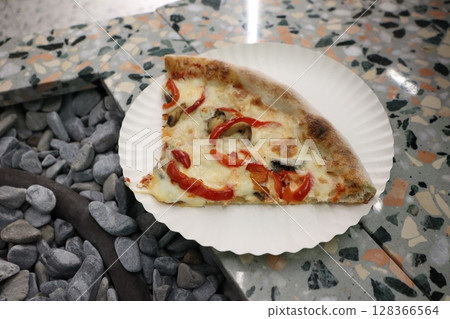 A Delicious and Mouthwatering Slice of Pizza Topped with Colorful Bell Peppers and Savory Mushrooms A Delicious and Mouthwatering Slice of Pizza Topped with Colorful Bell Peppers and Savory Mushrooms 128366564