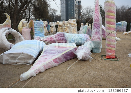 A collection of vibrant and colorful sculptures set within an urban park environment A collection of vibrant and colorful sculptures set within an urban park environment 128366587