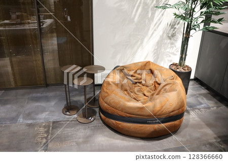 Inviting Cozy Contemporary Bean Bag accompanied by Modern Side Tables in a Stylish Setting Inviting Cozy Contemporary Bean Bag accompanied by Modern Side Tables in a Stylish Setting 128366660