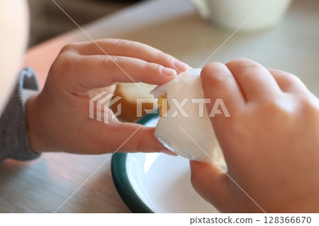 A joyful child relishing the experience of eating a delightful soft boiled egg for breakfast 128366670