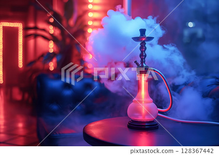 hookah shisha in smoke on table in cafe bar with neon light close-up on multicolored background 128367442