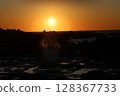Waves and sunsets 128367733