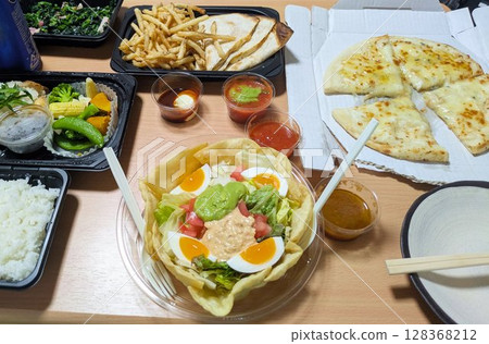 Enjoy dinner with delivery food - salad, pizza, french fries, tortillas, naan Enjoy dinner with delivery food - salad, pizza, french fries, tortillas, naan 128368212