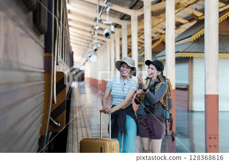 Happy Travelers with Luggage and Backpacks at Train Station Ready for Adventure 128368616