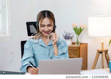 Young Professional Woman Working from Home with Laptop and Headset in Modern Home Office Setting 128368696