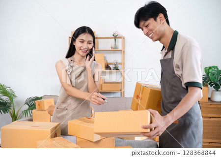 e-commerce business is writing a list of customers on paper, Business woman run an e-commerce business on website and social media. Selling product online 128368844