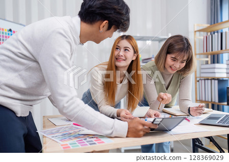 Creative Team Collaborating on UX UI Design Project in Modern Office Environment Creative Team Collaborating on UX UI Design Project in Modern Office Environment 128369029