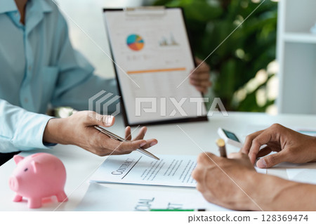 Young Couple Engaged in Financial Planning and Budgeting and signature with Documents and Adviser Financial 128369474