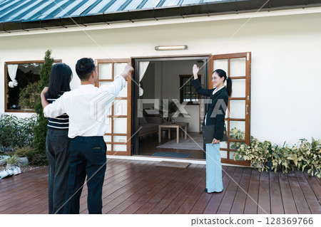 Real Estate Agent Showing and Present a New Home to Mature Couple 128369766