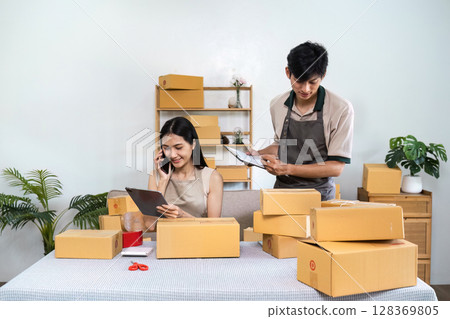 Young Entrepreneurs Managing Online order in a Home Office for Their Small Business Young Entrepreneurs Managing Online order in a Home Office for Their Small Business 128369805