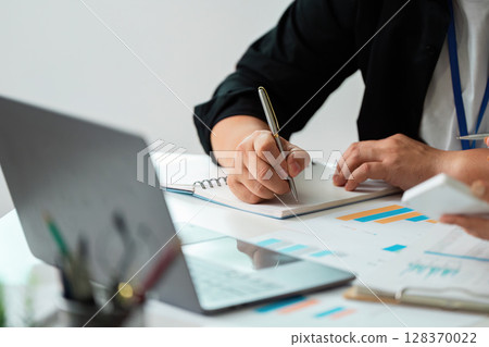 Business Collaboration. Professionals discussing financial data in a meeting. Business Collaboration. Professionals discussing financial data in a meeting. 128370022