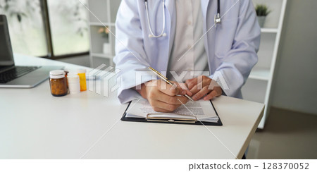 Healthcare Professional Writing Prescription in Medical Office Healthcare Professional Writing Prescription in Medical Office 128370052