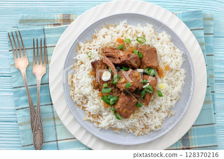 beef slow cooked with gravy served over rice beef slow cooked with gravy served over rice 128370216