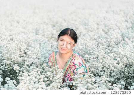 Woman (LGBTQ) posing at flower park garden field 128370290