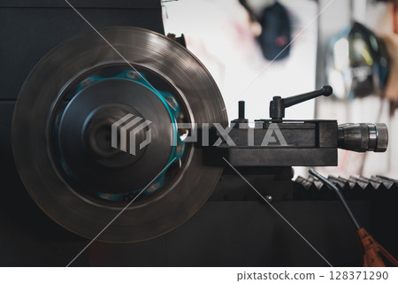 Checking car brake system for repair at car garage Checking car brake system for repair at car garage 128371290