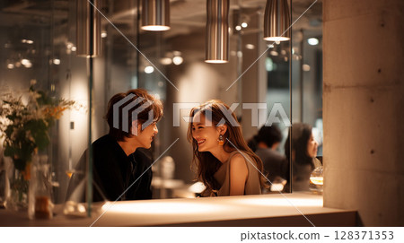 Couple smiling under warm lighting | Modern urban cafe scene 128371353