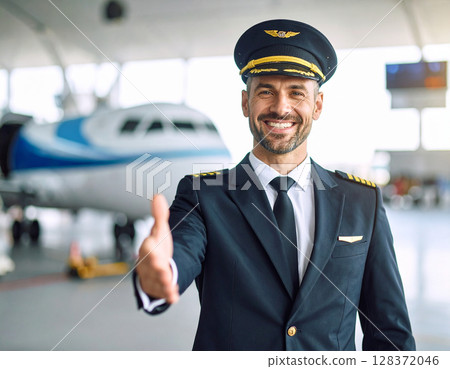 AI generated image of a professional airline captain in full uniform gesturing to welcome passengers at a busy airport terminal 128372046