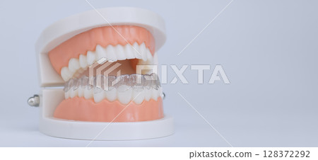 Clear dental aligner on tooth model 128372292