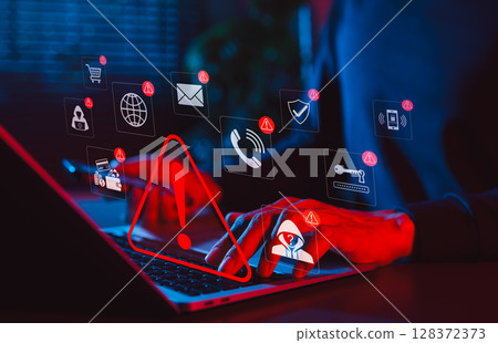 Online scam alert and cybersecurity warning concept. Man holding phone while using laptop, warning sign for scam with icons online threats, phishing, cyber secure, unknown person, suspicious scammer, 128372373
