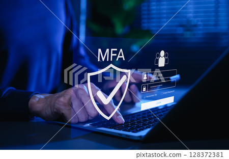 MFA, Multi-Factor Authentication Security Concept. Person typing on laptop with MFA shield icon and login interface, representing multi factor authentication, secure login, cybersecurity protection. 128372381