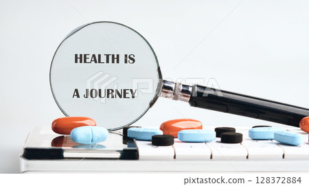 THE CONCEPTUAL PHRASE HEALTH IS A JOURNEY. Wellness and longevity concept. THE CONCEPTUAL PHRASE HEALTH IS A JOURNEY. Wellness and longevity concept. 128372884