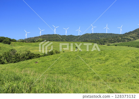 Photographing a landscape with wind turbines generating electricity against a clear blue sky Photographing a landscape with wind turbines generating electricity against a clear blue sky 128373132