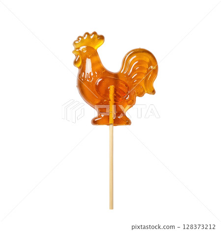 Transparent caramel colored rooster shaped lollipop on a stick 128373212