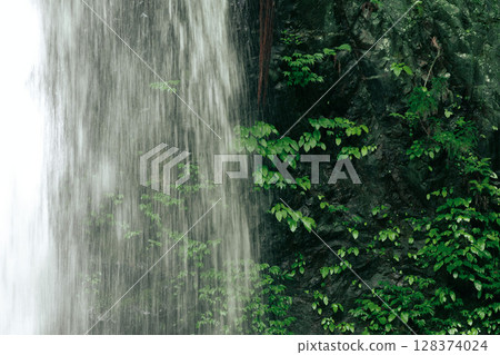 Slow shutter shot of part of a cascading waterfall Slow shutter shot of part of a cascading waterfall 128374024