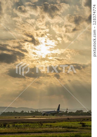 Sendai Airport at dusk, airplane taking off, Natori City, Miyagi Prefecture Sendai Airport at dusk, airplane taking off, Natori City, Miyagi Prefecture 128374774