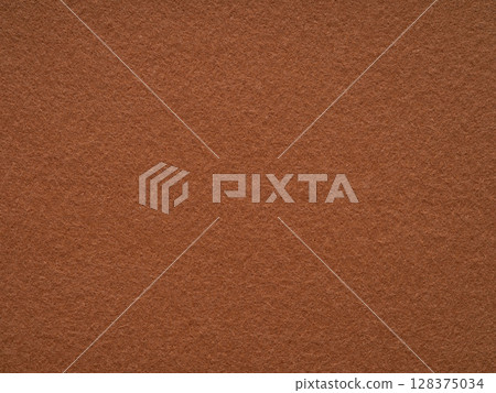 A rustic canvas of terracotta, this felt surface exudes an earthy warmth, akin to a sun-baked clay vessel 128375034