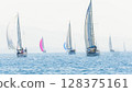 Sailing in morning haze. Regatta at the sea near the coast of Piraeus. 128375161