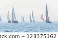 Sailing in morning haze. Regatta at the sea near the coast of Piraeus. 128375162