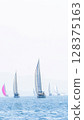 Sailing in morning haze. Regatta at the sea near the coast of Piraeus. 128375163
