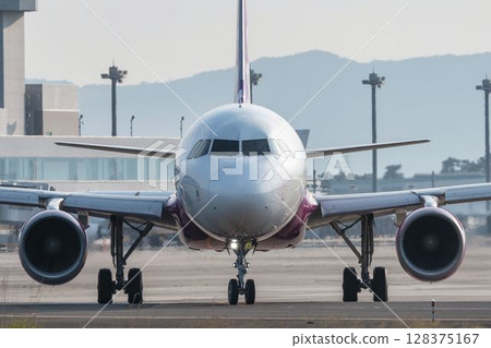 Sendai Airport at dusk, plane taxiing, Natori City, Miyagi Prefecture 128375167