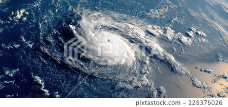 Hurricane forming over ocean with swirling clouds and intense eye visible from satellite view in daylight 128376026