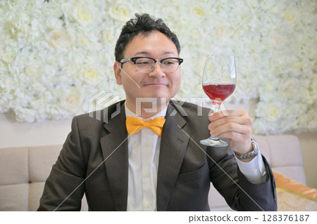 Man holding a wine glass Man holding a wine glass 128376187