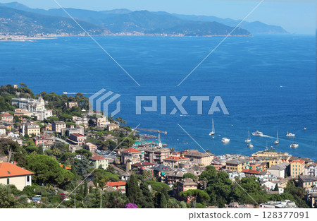 Camogli, Italy - 11 July 2025. Yachts, boats in bay of Liguria. Sea and tourism in Italy. Traditional buildings. Background for design. 128377091