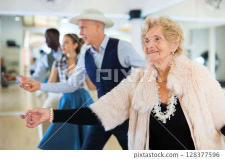 Jazz dancers standing in row and flicking with fingers Jazz dancers standing in row and flicking with fingers 128377596