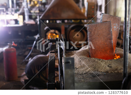 Ferrous metal billet is melted in an induction furnace closeup 128377610
