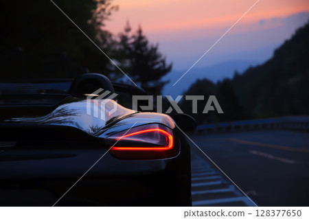 A black convertible with the morning glow reflected on its body A black convertible with the morning glow reflected on its body 128377650
