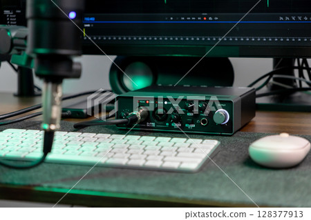 Professional audio interface and microphone setup on a desk, ready for recording, music production, or podcasting in a modern home studio 128377913