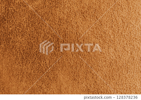 Close up, macro structure of orange suede fabric with abstract embossed shabby, messy texture. 128378236