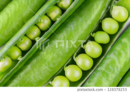 Macro food background with open green pea pods with round peas inside, natural texture and freshness Macro food background with open green pea pods with round peas inside, natural texture and freshness 128378253