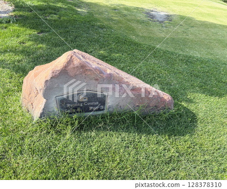 Sign on a Large Rock Marking the Putting Course on a Well-Maintained Lawn Sign on a Large Rock Marking the Putting Course on a Well-Maintained Lawn 128378310