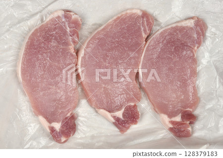 Raw pork chops Raw pork chops 128379183
