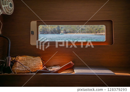 View from the cabin window of a sailing yacht anchored near Croatian islands. Peace, minimalism, slow living and connection with nature at sea. 128379293