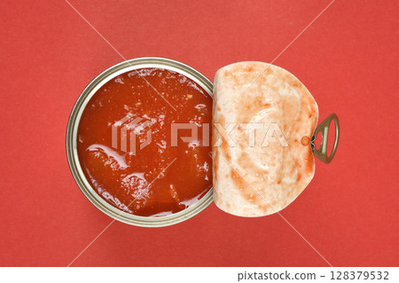 Open can of chunky red tomato sauce Open can of chunky red tomato sauce 128379532