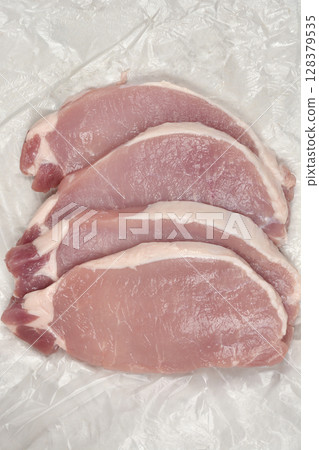 Raw pork chops Raw pork chops 128379535