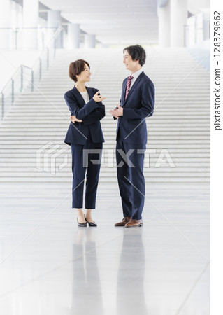 Male and female business people in suits 128379662